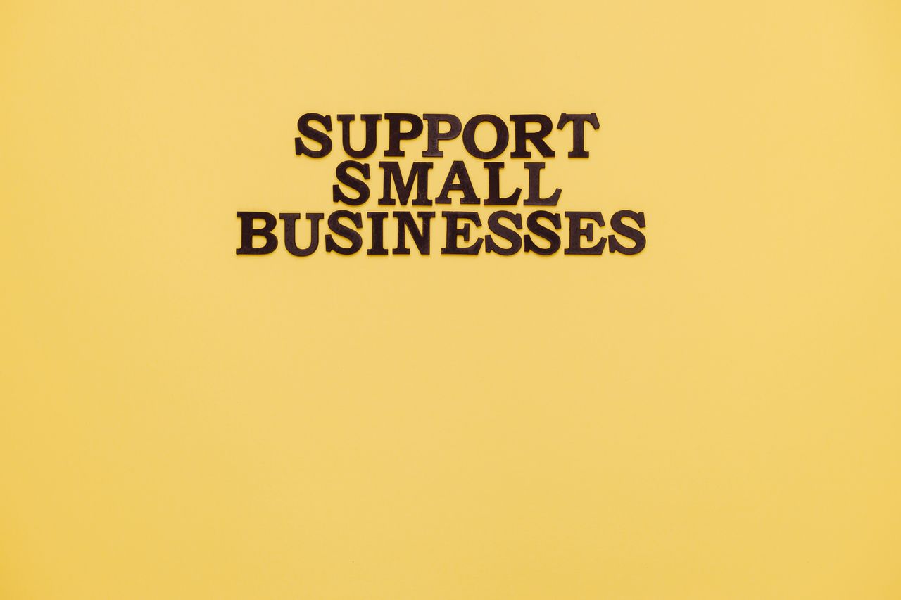 Crafting Captivating Headlines: Your awesome post title goes here Inspirational image with 'Support Small Businesses' text on a warm yellow background.